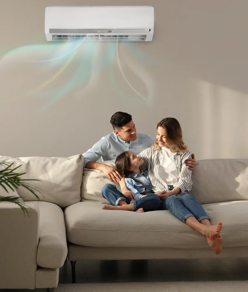 Happy family spending time on the couch enjoying the cool and refreshing air from the air conditioner