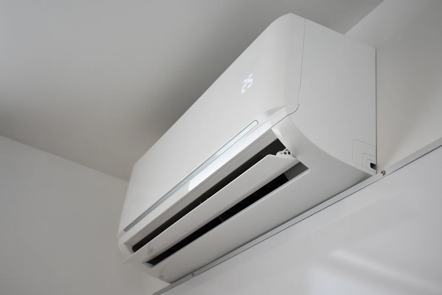 A white air conditioning unit installed on the wall, illustrating a standard feature for home cooling solutions.
