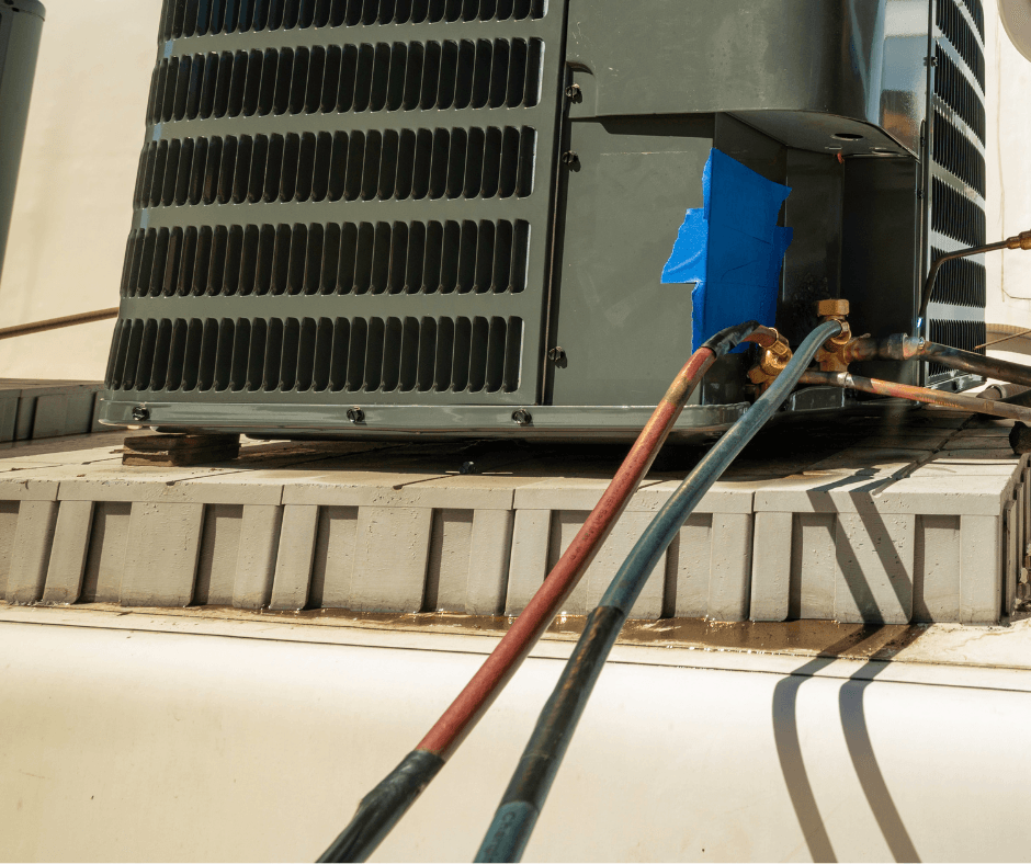 HVAC technician servicing condensation drain lines on an outdoor air conditioning unit