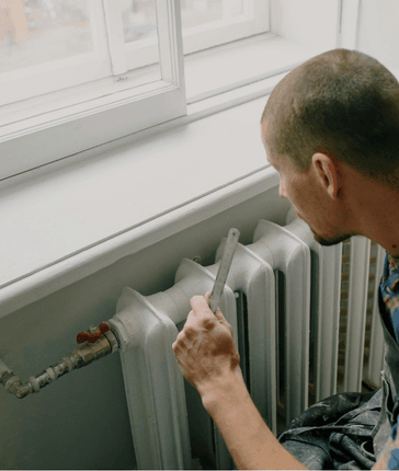 HVAC Service Guy Working On Furnace